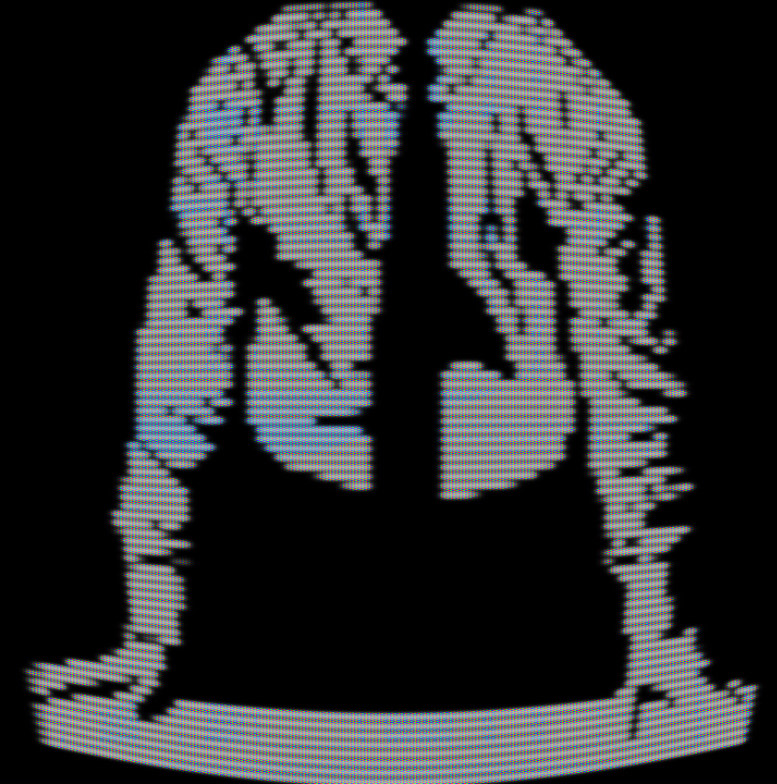 A black and white CRT filtered neck down shot of an office worker (assumed to be #787878) with their hands on a desk in front of them.
